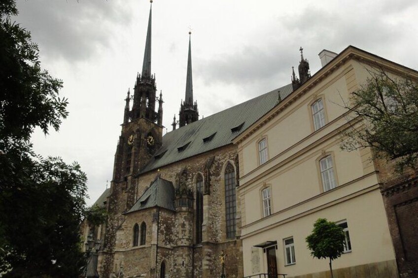 A historic church with two tall spires and a clock tower. 1