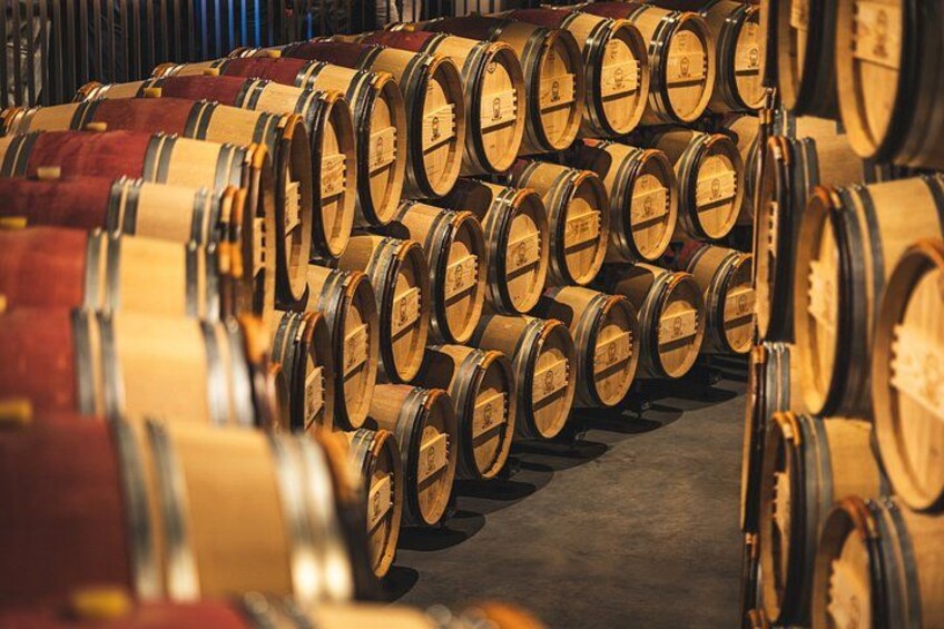 File di barili di legno impilati in un magazzino. 5