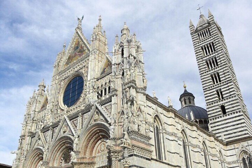 A Gothic cathedral with intricate architecture and a prominent clock tower. 4