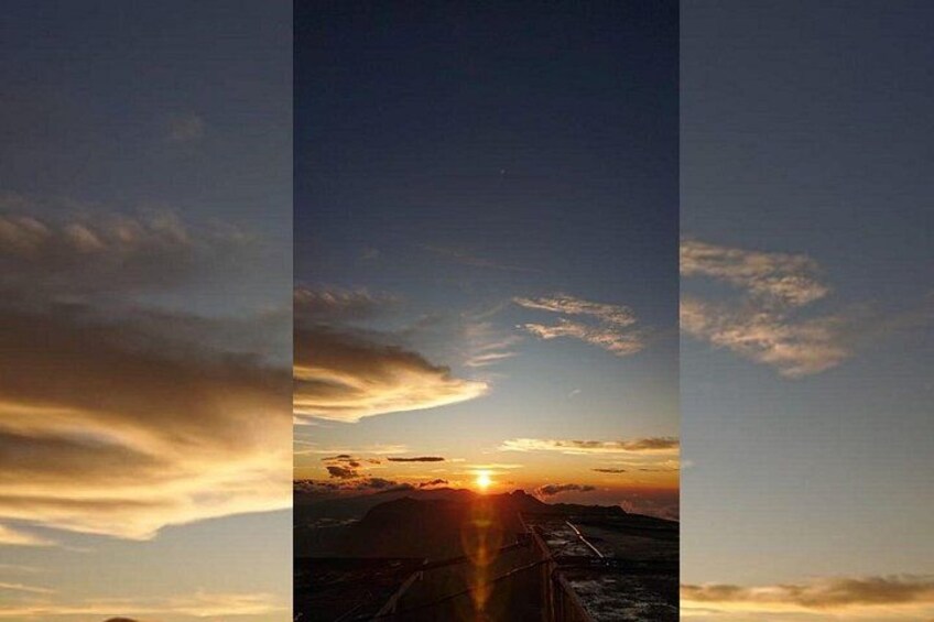 A sunset over a bridge with clouds in the sky. 4