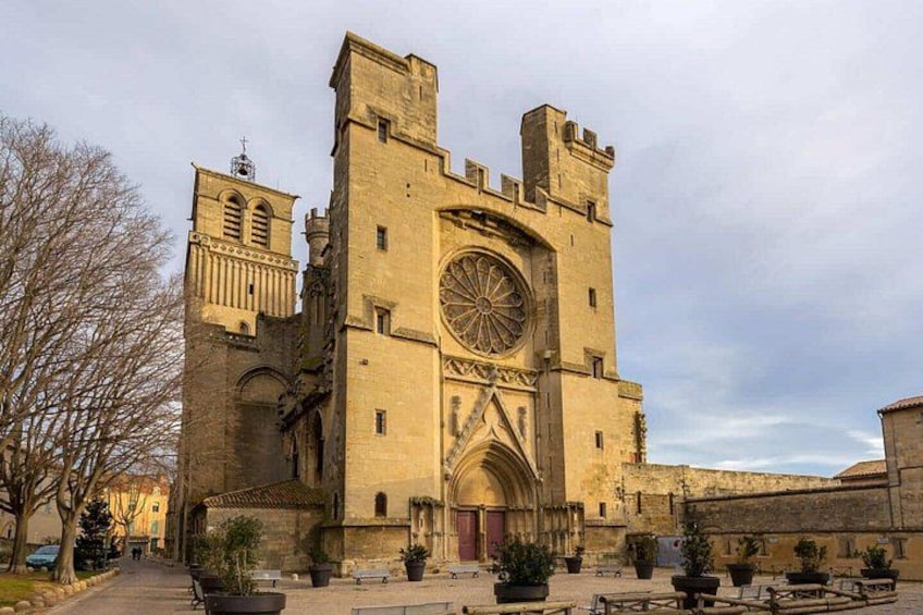 A historic stone building with a large circular window and a tall tower. 3