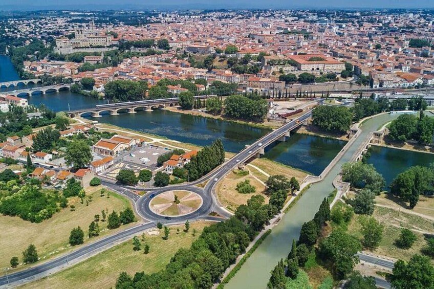 A cityscape with a river, bridges, and a roundabout. 2