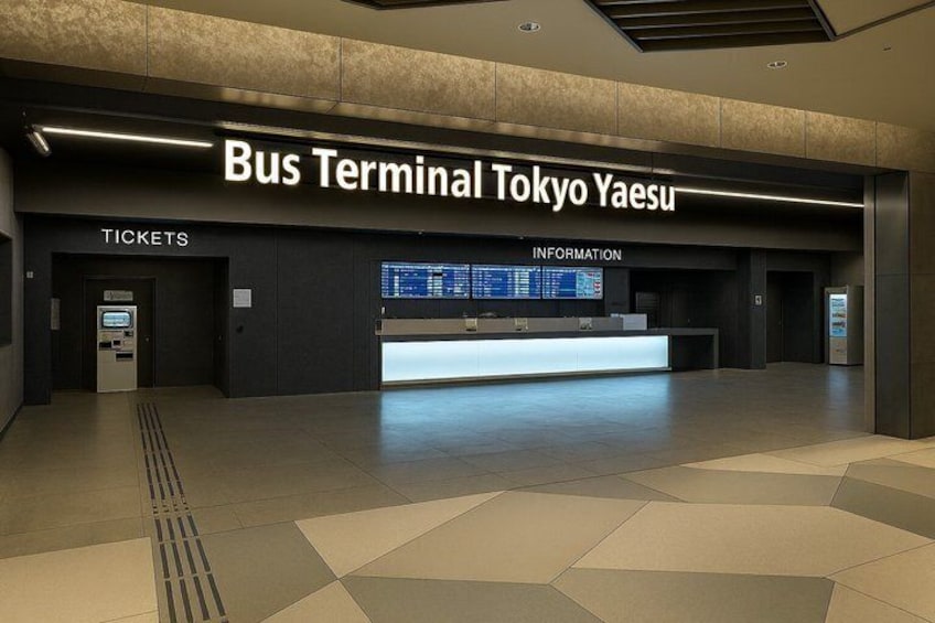 A bus terminal with a ticket counter and an information desk. 2