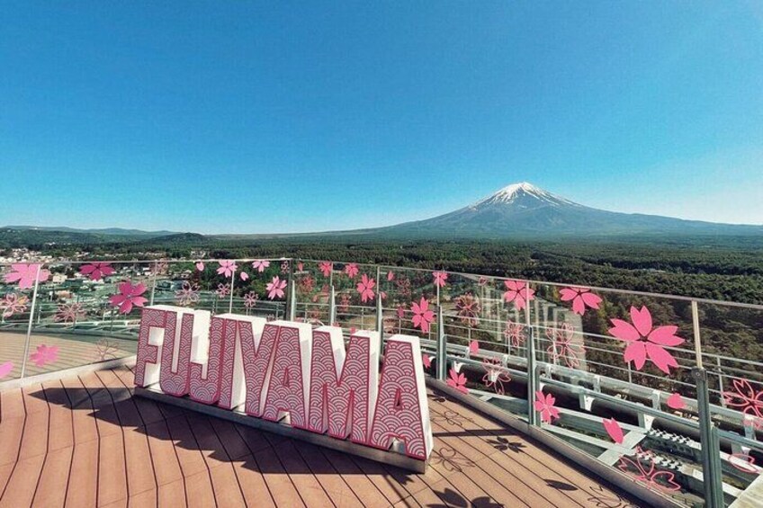 A sign reading "FUJIYAMA" with a view of Mount Fuji in the background. 1