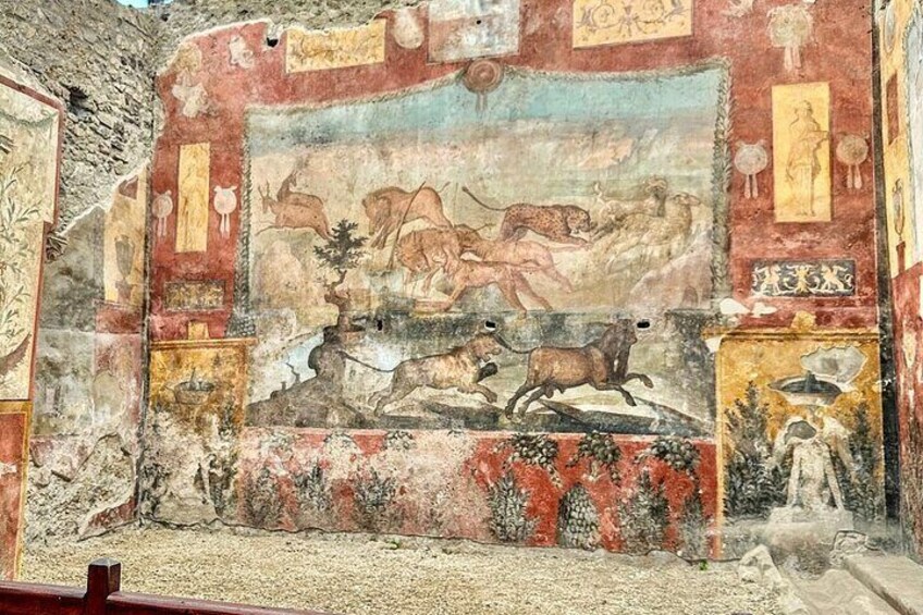 A fresco with a hunting scene, a landscape, and decorative panels. 1