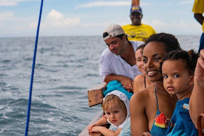 A group of people on a boat with the ocean in the background. 5