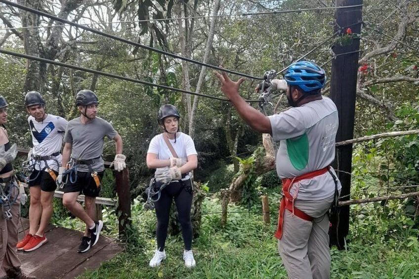 A group of people on a rope course with a guide. 3