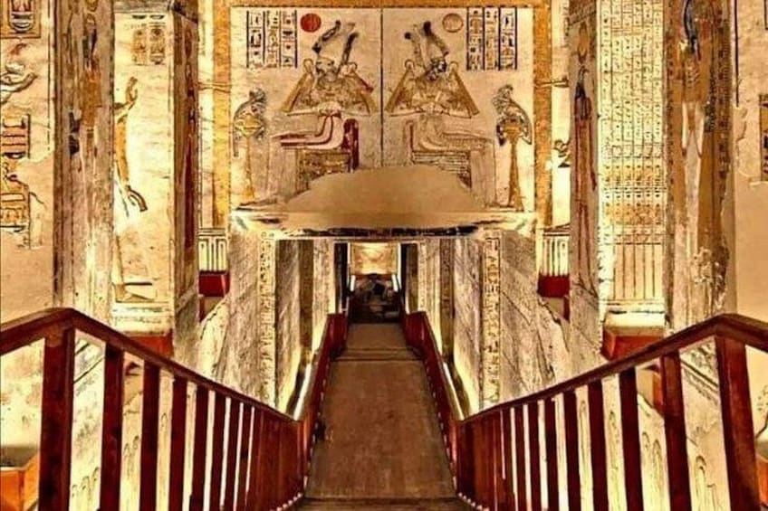 A corridor with hieroglyphs and a wooden staircase. 4