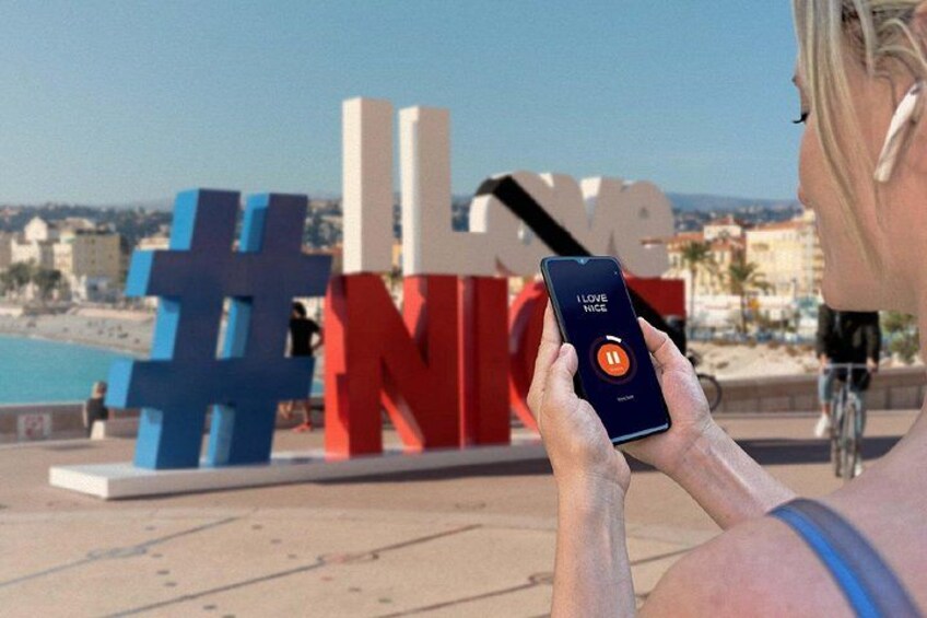 A person taking a photo with a smartphone in front of a '#LoveNIKE' sign. 3