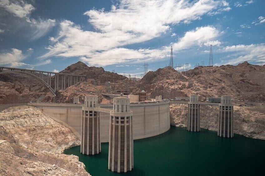 A hydroelectric dam with multiple water towers and a bridge. 5