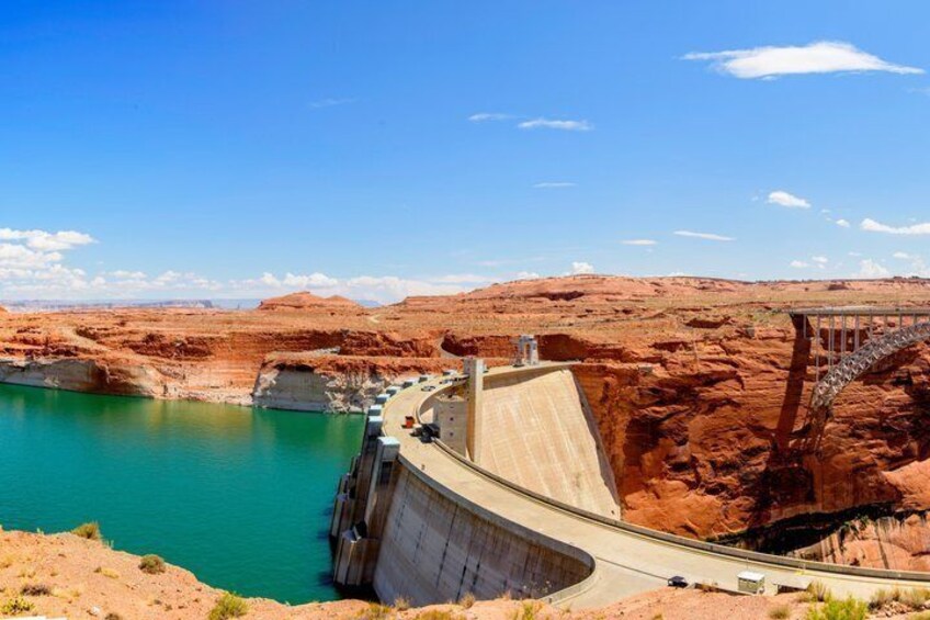A dam with a spillway, a reservoir, and a bridge. 2