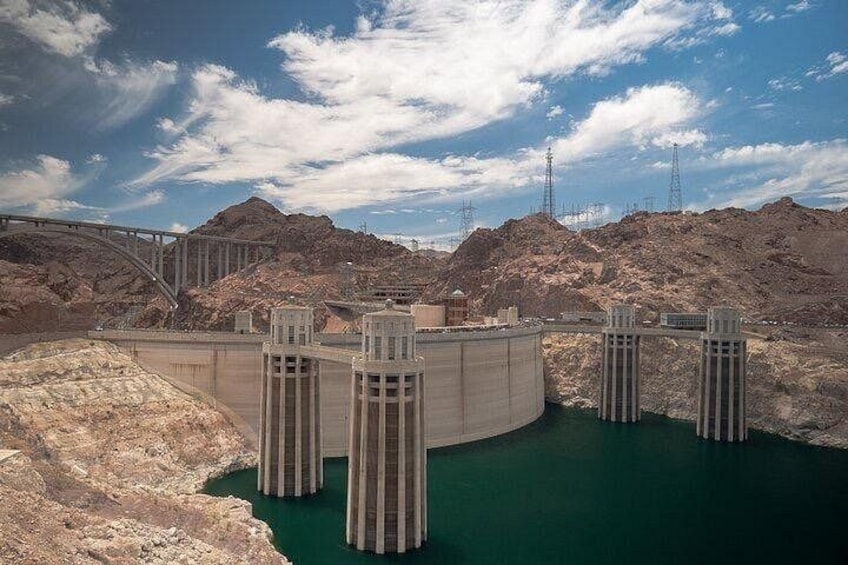 A hydroelectric dam with multiple spillways and a bridge crossing over the reservoir. 5