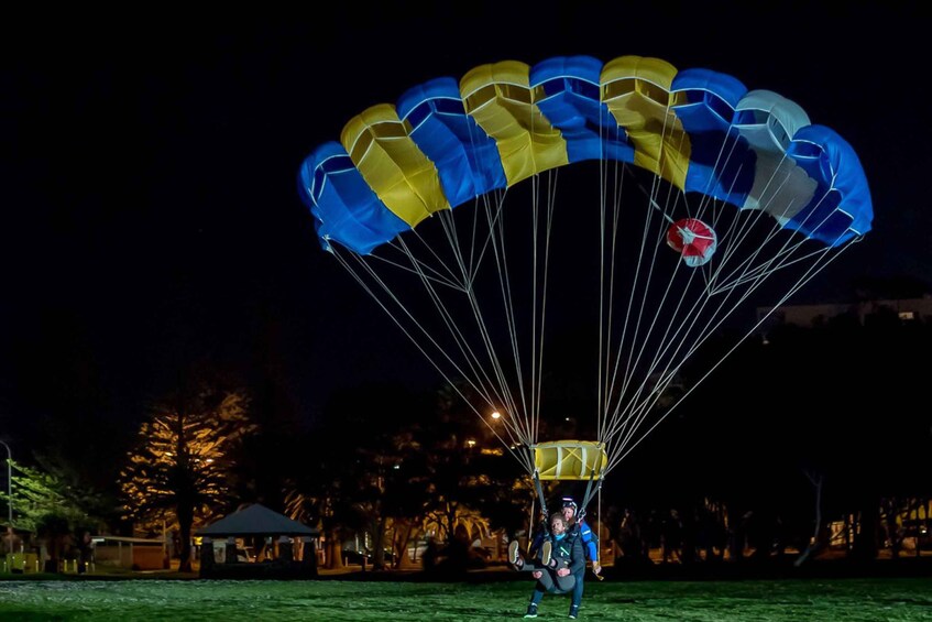 A person preparing to parachute with a parachute canopy. 5