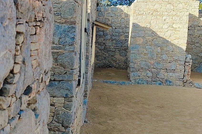 A stone building with a window and a doorway. 3