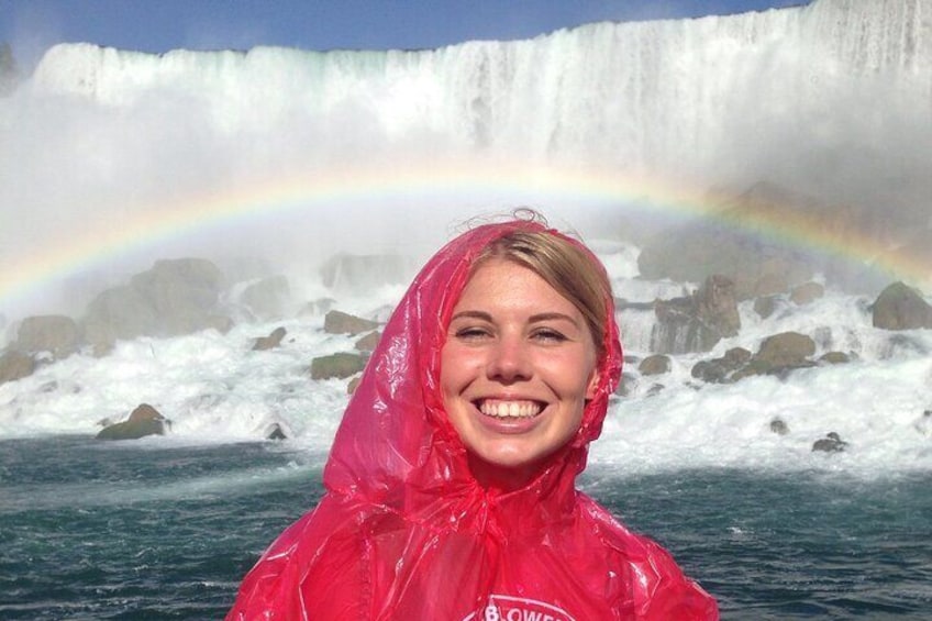 A person in a red raincoat with a rainbow in the background. 1