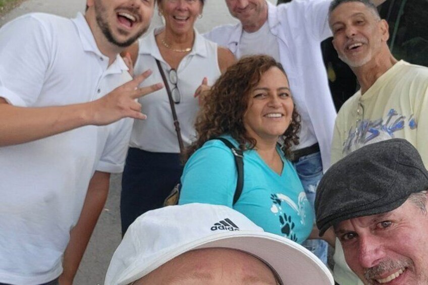 A group of people outdoors, some wearing casual clothing. 2