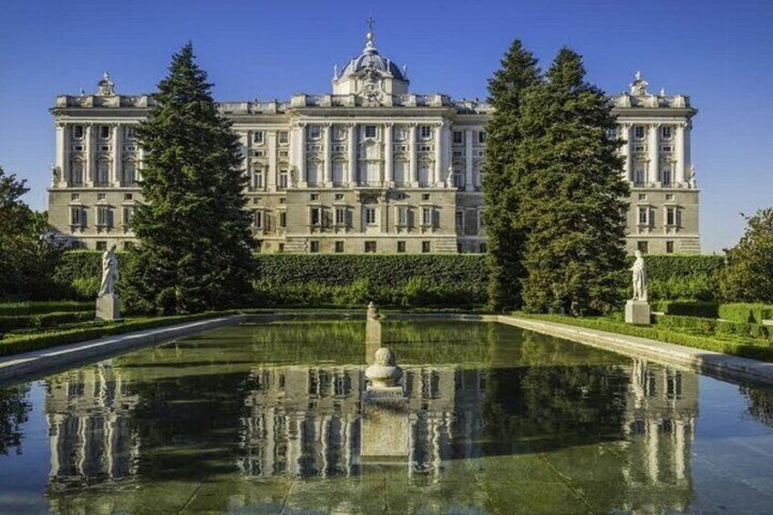 A grand palace with a symmetrical garden and a reflecting pool. 1