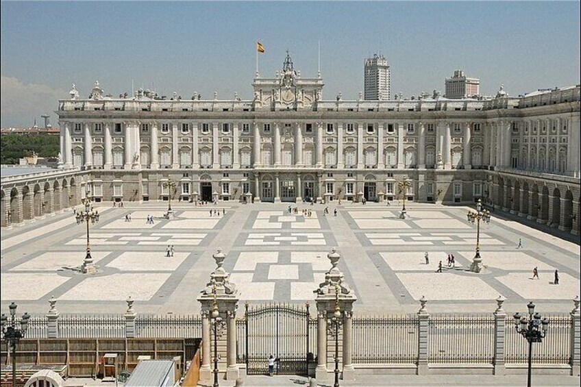 A grand palace with a large courtyard, ornate gates, and a symmetrical facade. 5