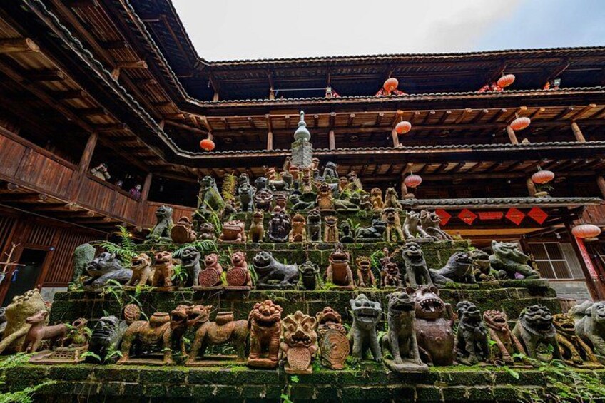 A traditional building with a tiered roof and a staircase adorned with animal sculptures. 2