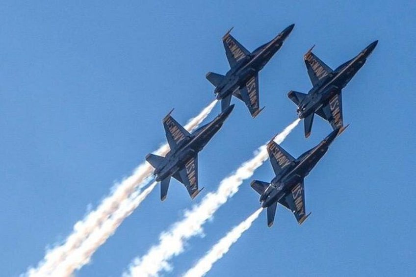 Four military jets flying in formation with smoke trails. 1