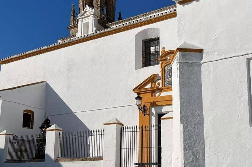 A white building with a brown door and a small window. 4