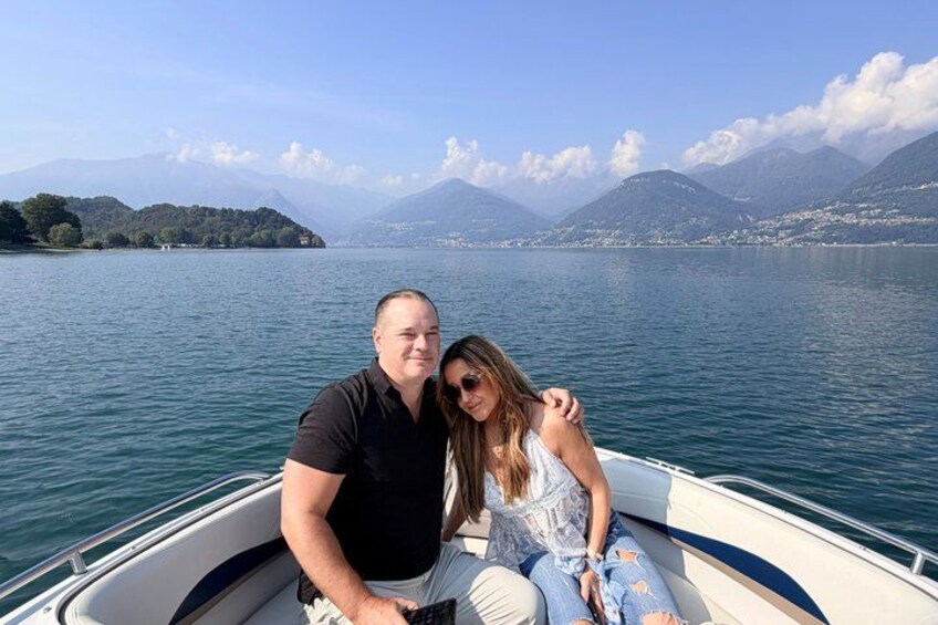 A boat on a lake with mountains in the background. 2