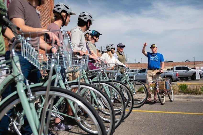 A group of people on bicycles in a parking lot. 3