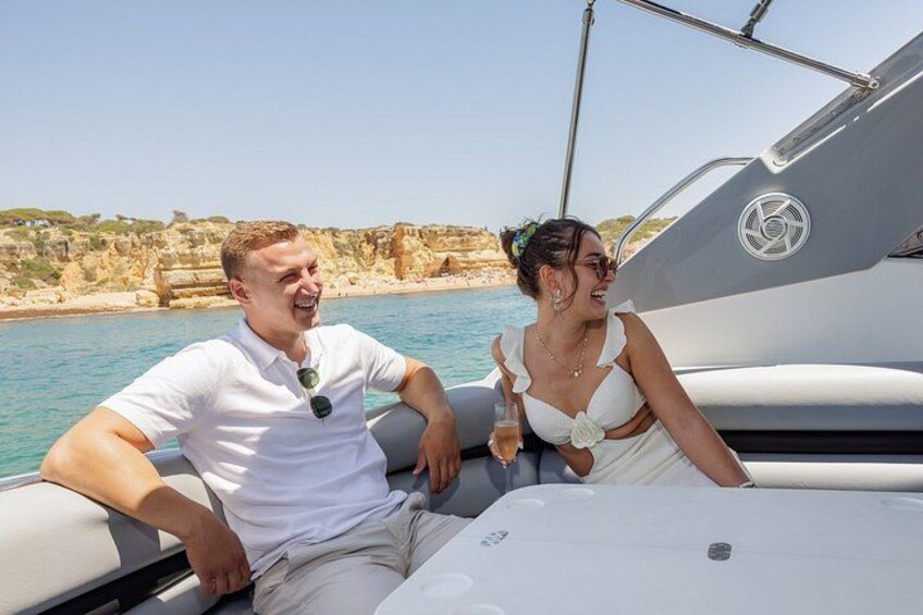 A man and a woman on a boat near rocky cliffs. 5