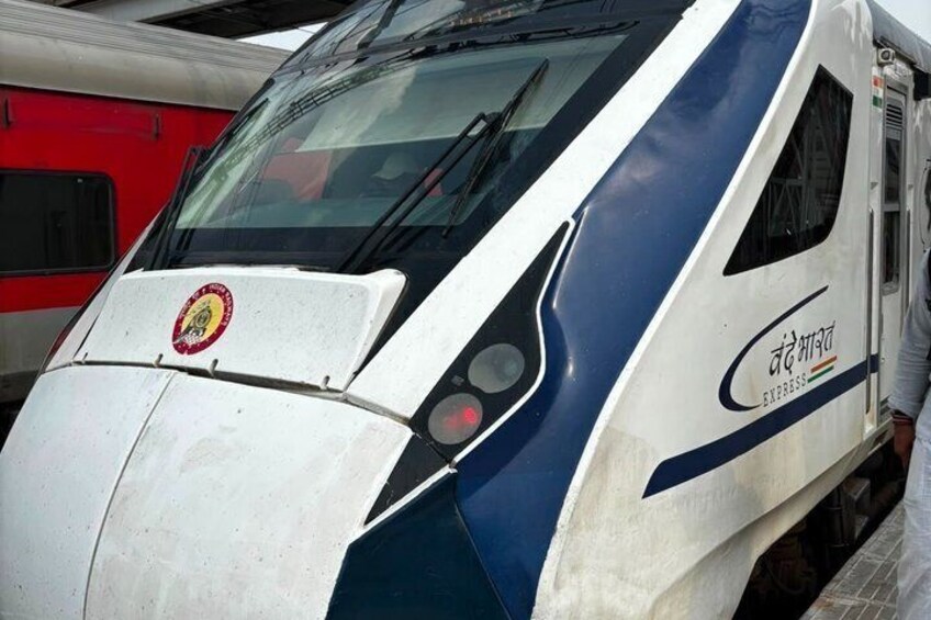 A modern train with a sleek design, featuring a prominent logo and the word 'EXPRESS' on its side. 5