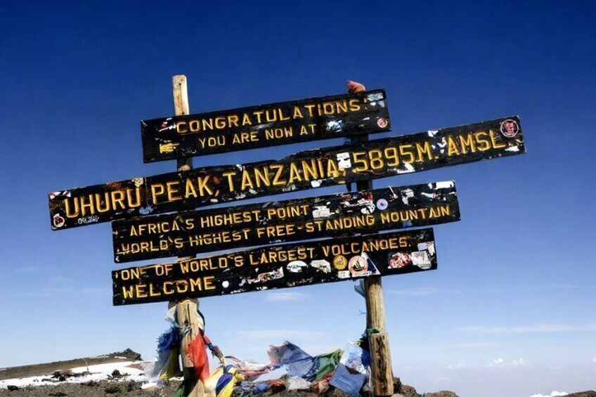 A signpost at Uhuru Peak, Tanzania, indicating it is Africa's highest point and one of the world's largest volcanoes. 2