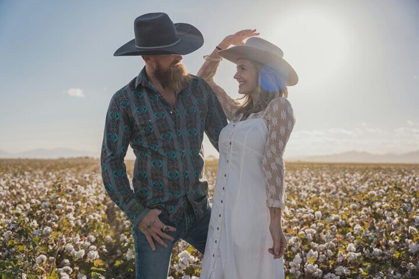 A couple in a cotton field with a clear sky. 3