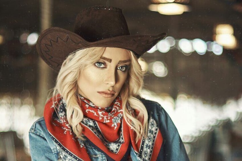 A person wearing a cowboy hat and a denim jacket with a red scarf. 4