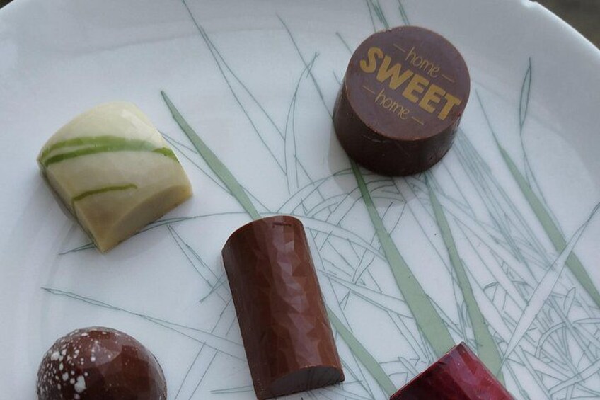 A plate with various food items including a cylindrical object, a heart-shaped item, and a round item with a label. 3