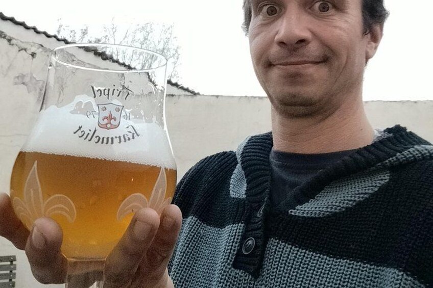 A person holding a beer glass with a logo. 4