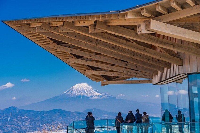 A wooden structure with a glass enclosure overlooking a snow-capped mountain. 5