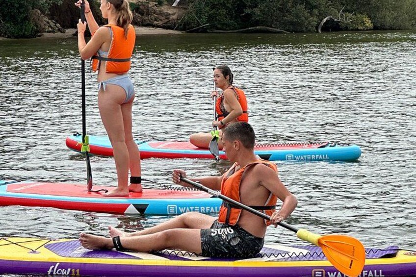 People on paddleboards in a body of water. 5