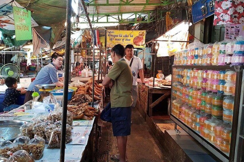 A market stall with fresh produce and packaged goods. 4