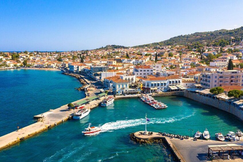 A coastal town with a harbor, boats, and buildings. 1