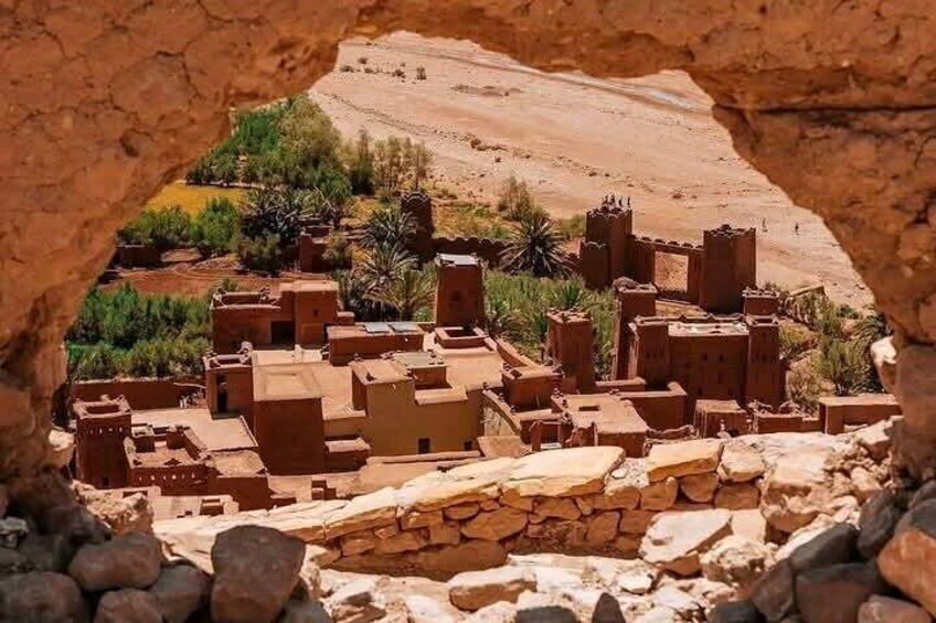 A traditional village with adobe buildings nestled in a rocky landscape. 4