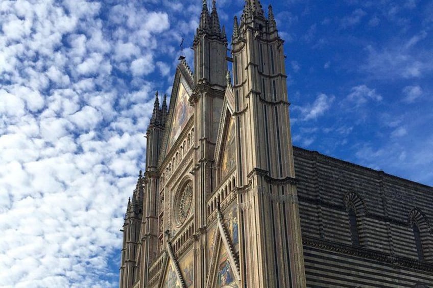 A Gothic-style cathedral with intricate spires and a large circular window. 2