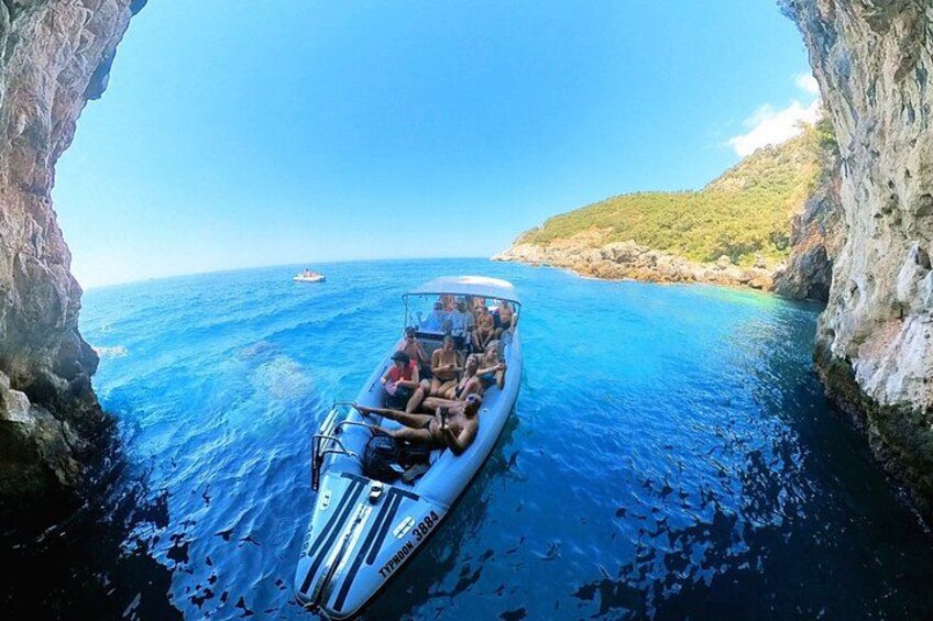 A boat with passengers navigating through a narrow waterway between rocky cliffs. 3