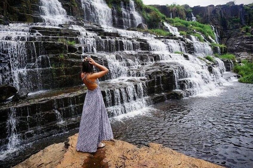 A waterfall with a person taking a photo. 4