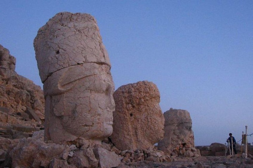 Rock formations with a person standing in the background. 1