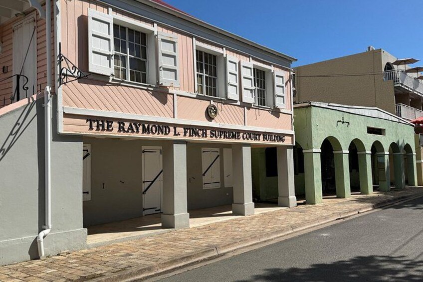 A historic building labeled 'The Raymond L. Finch Supreme Court Building.' 5