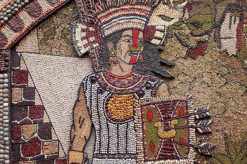 A detailed mosaic with a figure wearing a headdress and holding a shield. 2