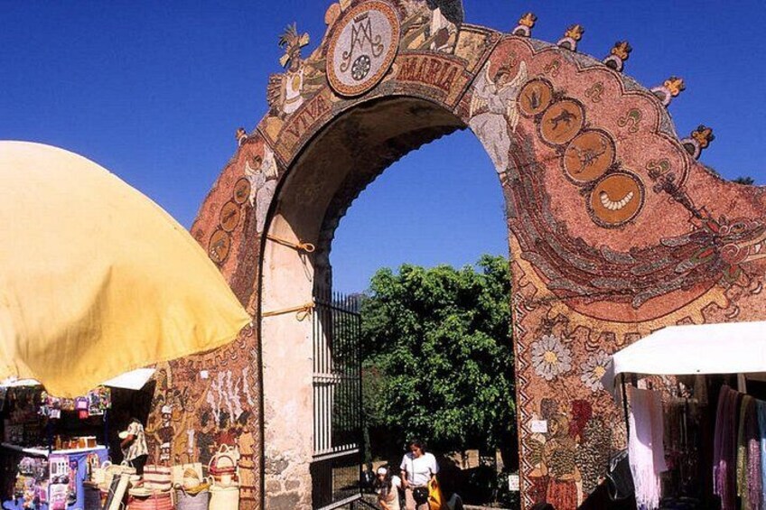 A mosaic archway with intricate designs and the word 'MARIA' visible. 1