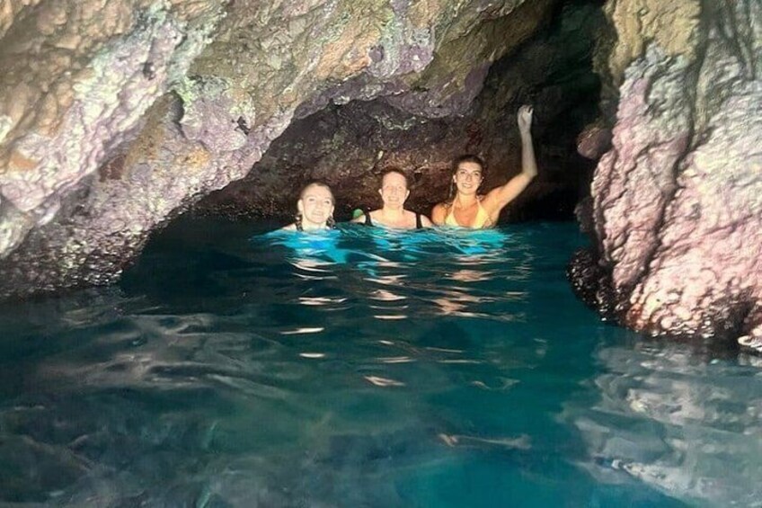 A cave with clear water and rocky walls. 2