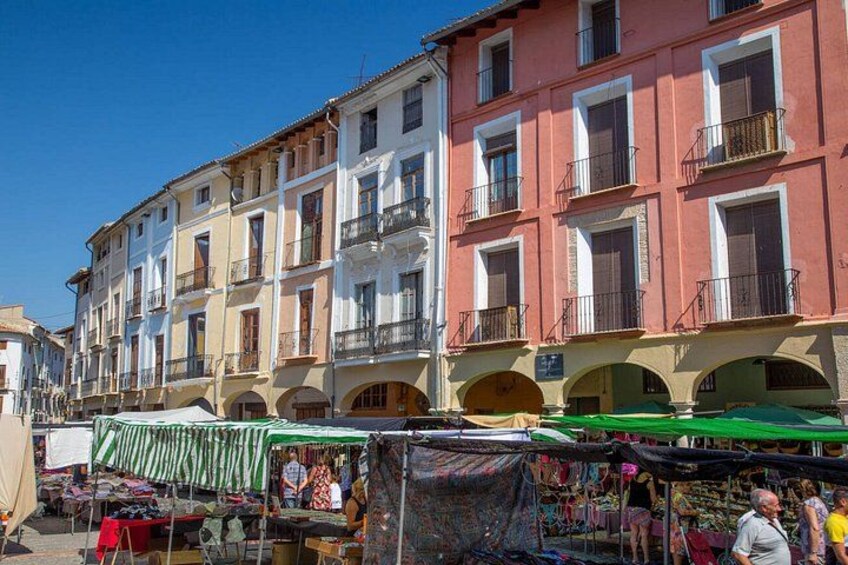 A street market with stalls and people. 3