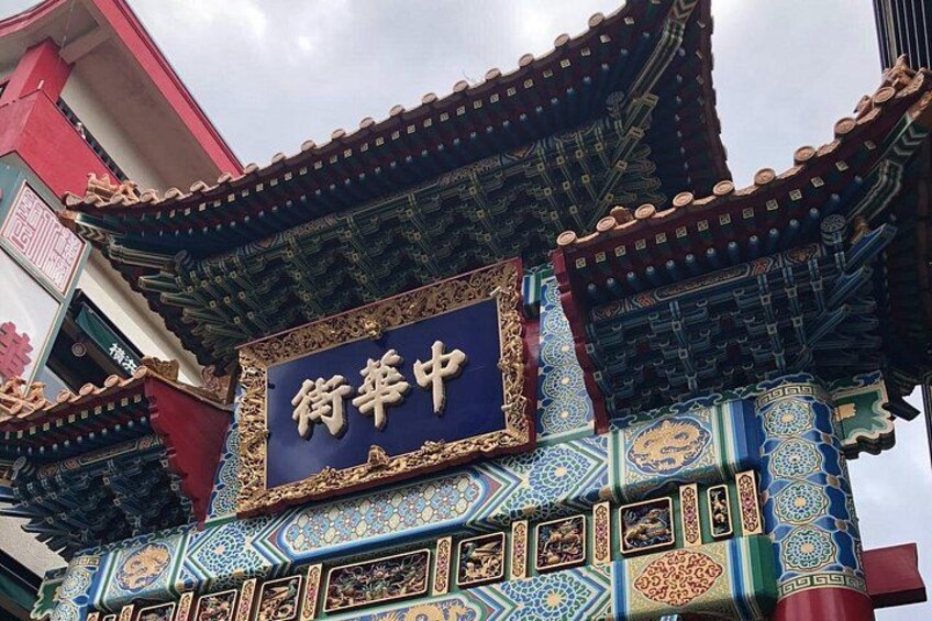 Traditional Chinese architecture with ornate decorations and a sign that reads '街坊中'. 3