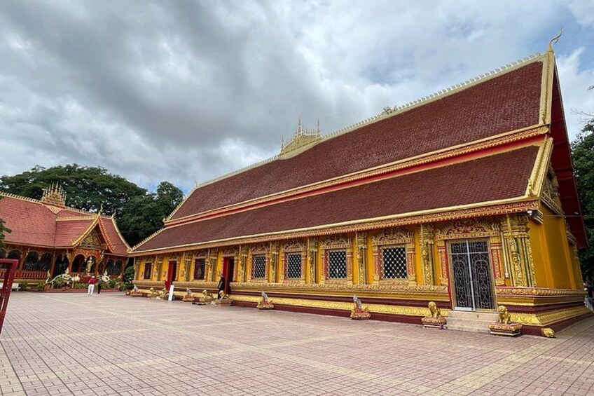 A traditional Thai temple with ornate architecture and a tiled courtyard. 2